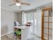 Bright office space featuring a ceiling fan, natural light, and practical built-in desk and storage at 2920 Waverly Place Dr, Dacula, GA 30019