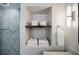 Bathroom features a shower with marble tiling, a wood shelf with towels, and modern lighting fixtures at 4493 Orleans Dr, Dunwoody, GA 30338