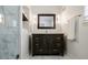 Elegant bathroom features a dark wood vanity, marble floors, modern fixtures, and a glass-enclosed shower at 4493 Orleans Dr, Dunwoody, GA 30338