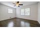 Bright, airy bedroom boasts hardwood floors, two windows, and neutral walls, providing ample natural light at 4493 Orleans Dr, Dunwoody, GA 30338