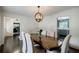 Elegant dining room with a wooden table, upholstered chairs, and a view to the kitchen and office at 4493 Orleans Dr, Dunwoody, GA 30338