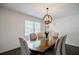 Well-lit dining room with a large wooden table, six chairs, and a decorative chandelier at 4493 Orleans Dr, Dunwoody, GA 30338