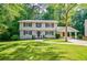 Charming two-story home with a manicured lawn and inviting walkway, surrounded by lush trees at 4493 Orleans Dr, Dunwoody, GA 30338