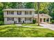 Charming two-story home with a well-manicured lawn, gray shutters, and a convenient attached carport at 4493 Orleans Dr, Dunwoody, GA 30338