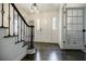 Elegant foyer with dark wood floors, staircase, and a clear view of the front door at 4493 Orleans Dr, Dunwoody, GA 30338