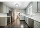 Modern kitchen with stainless steel appliances, light gray cabinets, and hardwood floors at 4493 Orleans Dr, Dunwoody, GA 30338