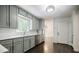 Bright kitchen features stainless steel appliances, shaker cabinets and dark hardwood floors at 4493 Orleans Dr, Dunwoody, GA 30338