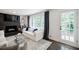 Sun-filled living room with fireplace, hardwood floors, and large windows at 4493 Orleans Dr, Dunwoody, GA 30338