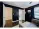 Spacious main bedroom showcases dark walls, an ensuite bathroom, and a plush seating area by the window at 4493 Orleans Dr, Dunwoody, GA 30338