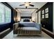 Stylish main bedroom boasts dark walls, a canopy bed, decorative art, and a comfortable velvet bench at 4493 Orleans Dr, Dunwoody, GA 30338