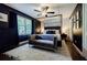 Chic main bedroom features dark walls, a plush rug, a four-poster bed, and ample natural light at 4493 Orleans Dr, Dunwoody, GA 30338