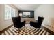 Cozy office space featuring a wooden desk, accent wall, and comfortable seating area at 4493 Orleans Dr, Dunwoody, GA 30338