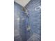 Modern shower with a dual showerhead and sleek blue subway tile at 4493 Orleans Dr, Dunwoody, GA 30338