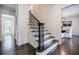 Elegant staircase with dark wood steps and decorative iron railings, leading to the upper level at 4493 Orleans Dr, Dunwoody, GA 30338