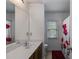 Bathroom featuring a double sink vanity, a large mirror, and a shower with red floral curtains at 4619 Sweetwater Ave, Powder Springs, GA 30127