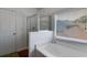 Bright bathroom featuring a tub, and separate glass-enclosed shower at 4619 Sweetwater Ave, Powder Springs, GA 30127