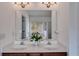 Bathroom featuring double sinks, vanity and large mirror at 4619 Sweetwater Ave, Powder Springs, GA 30127