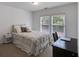 Cozy bedroom featuring a neutral color palette, plush bedding, and a window with natural light at 4619 Sweetwater Ave, Powder Springs, GA 30127