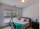 Comfortable bedroom with a cheerful bedding set, natural lighting, and a dark wood nightstand at 4619 Sweetwater Ave, Powder Springs, GA 30127