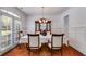 Elegant dining room with wainscoting, chandelier, and natural light from the door at 4619 Sweetwater Ave, Powder Springs, GA 30127