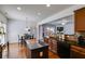 Open kitchen featuring wood cabinetry, black countertops, an island, and views to an adjacent dining area and living room at 4619 Sweetwater Ave, Powder Springs, GA 30127