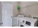 Laundry room with a side-by-side washer and dryer and white wire shelving for storage at 4619 Sweetwater Ave, Powder Springs, GA 30127