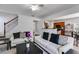 Spacious living area with staircase, view into the kitchen, and comfortable seating at 4619 Sweetwater Ave, Powder Springs, GA 30127