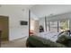 Spacious main bedroom with a four-poster bed, ensuite bathroom, a TV, and large windows at 4619 Sweetwater Ave, Powder Springs, GA 30127