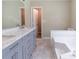 Bathroom vanity features a marble top with dual sinks and a gray cabinet at 5339 Biffle Downs Rd, Stone Mountain, GA 30088