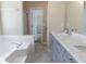 Bathroom features a bathtub, vanity, and doorway with a view to the bedroom at 5339 Biffle Downs Rd, Stone Mountain, GA 30088