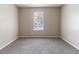 This bedroom features gray carpeting, neutral walls, and a window with blinds at 5339 Biffle Downs Rd, Stone Mountain, GA 30088