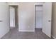 This bedroom includes neutral walls, gray carpeting, a closet, and two doors at 5339 Biffle Downs Rd, Stone Mountain, GA 30088