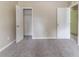 This bedroom offers neutral walls, gray carpeting, a closet, and doors at 5339 Biffle Downs Rd, Stone Mountain, GA 30088