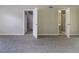 This bedroom has neutral walls, gray carpeting, and two doors at 5339 Biffle Downs Rd, Stone Mountain, GA 30088