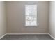 This bedroom has gray carpeting and a window with white blinds at 5339 Biffle Downs Rd, Stone Mountain, GA 30088