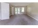 This bedroom has gray carpeting and doors that lead to a balcony at 5339 Biffle Downs Rd, Stone Mountain, GA 30088