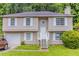 Charming home featuring a neutral exterior with a well-maintained front yard and bright white trim at 5339 Biffle Downs Rd, Stone Mountain, GA 30088