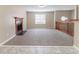 Open living space with plush carpeting, a charming fireplace, and views of the upper-level landing at 5339 Biffle Downs Rd, Stone Mountain, GA 30088