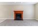 Cozy living room featuring plush carpeting and a classic wood-trimmed fireplace, perfect for relaxing at 5339 Biffle Downs Rd, Stone Mountain, GA 30088