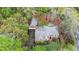 Aerial view of brick home with three car garage and lush landscaping at 6450 Oak Valley Dr, Cumming, GA 30040