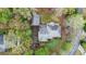 Charming house aerial view with garage, surrounding trees, and circular drive at 6450 Oak Valley Dr, Cumming, GA 30040