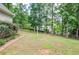 Spacious backyard with a well-manicured lawn and mature trees, ideal for outdoor activities and relaxation at 6450 Oak Valley Dr, Cumming, GA 30040