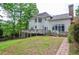 Expansive backyard featuring a large deck, mature trees, and meticulous landscaping, providing a private retreat at 6450 Oak Valley Dr, Cumming, GA 30040