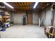 Unfinished basement with exposed ceiling, concrete walls and floor, and storage shelves at 6450 Oak Valley Dr, Cumming, GA 30040