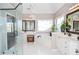 Bright bathroom features white cabinets, tub, double vanity, and glass shower with tile floor at 6450 Oak Valley Dr, Cumming, GA 30040