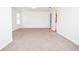Large carpeted room with natural lighting, and a doorway to a full ensuite bathroom at 6450 Oak Valley Dr, Cumming, GA 30040