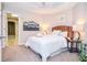 Cozy bedroom with a woven headboard, stylish decor, and an open doorway to another room at 6450 Oak Valley Dr, Cumming, GA 30040