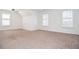 Spacious bedroom with neutral carpet, two windows, and lots of natural light, providing a cozy atmosphere at 6450 Oak Valley Dr, Cumming, GA 30040