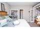 Inviting bedroom with hardwood floors, white bedding, and french doors leading to the outdoors at 6450 Oak Valley Dr, Cumming, GA 30040