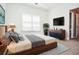 Stylishly staged bedroom featuring contemporary furniture, a comfortable king bed and bright window light at 6450 Oak Valley Dr, Cumming, GA 30040